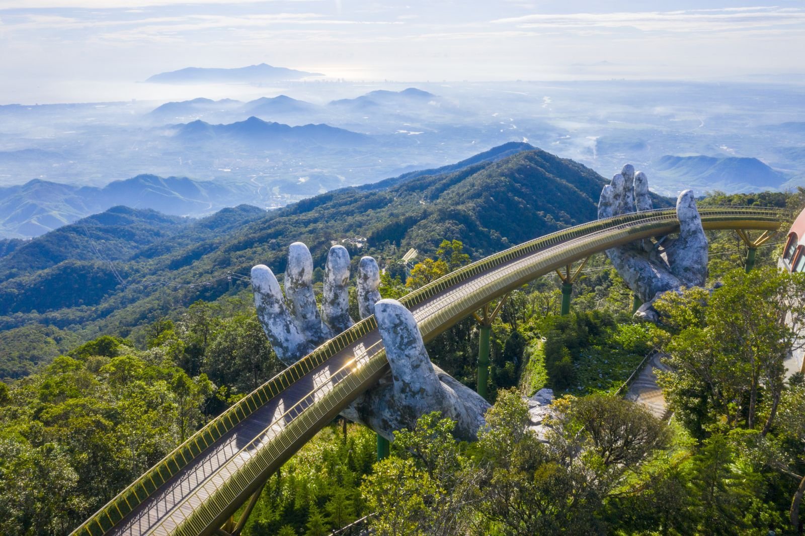 The Golden Bridge held by stone hands at Ba Na Hills