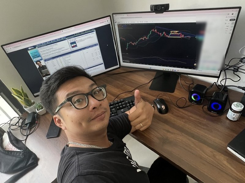 Kevin, founder of Green Candle Journeys, at his two-screen trading desk