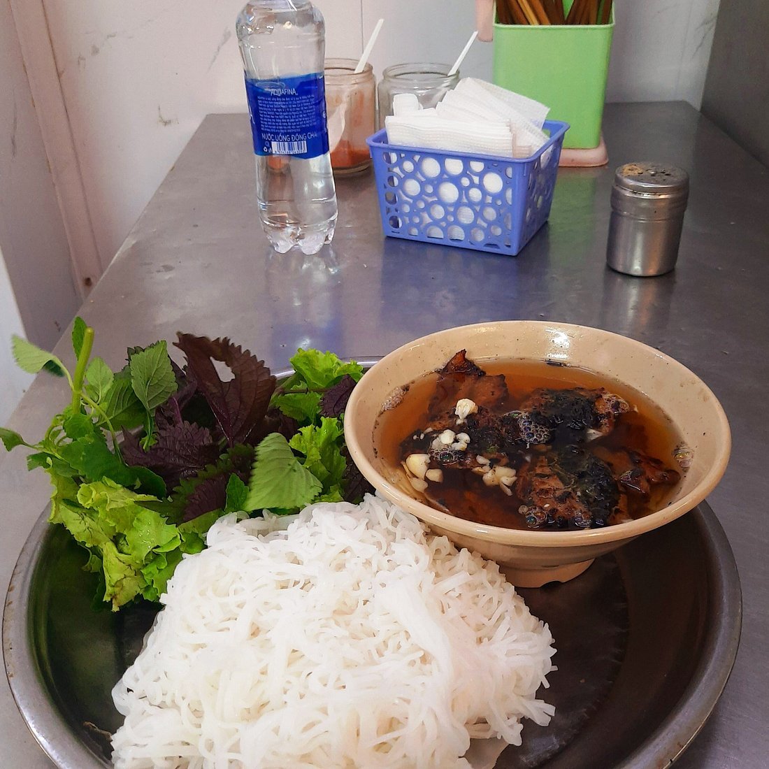 Bun cha with grilled pork, rice noodles and fresh herbs at a Hanoi lunch spot